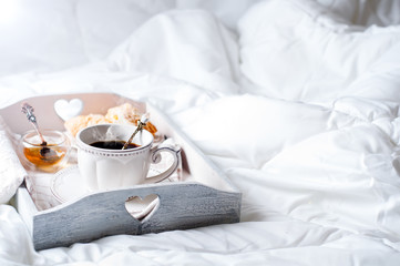 Wall Mural - wooden tray with light breakfast on bed