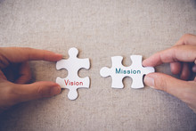Hands With Puzzle Pieces And "Vision And Mission" Words