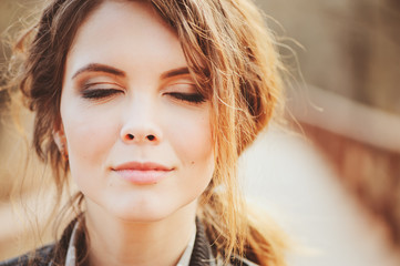 autumn outdoor portrait of young beautiful woman with natural makeup in leather jacket and plaid shirt, soft vintage toned