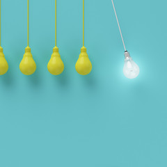 Hanging yellow light bulbs with glowing one different idea on light blue background , Minimal concept idea , flat lay , top