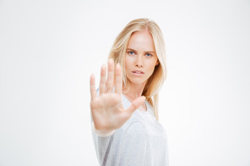 Portrait of a beautiful girl showing stop sign with palm