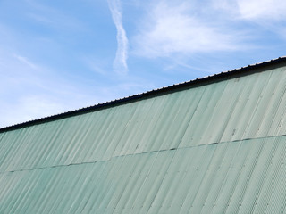 Wall Mural - green zinc roof with blue sky