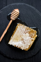 Poster - Above view of honeycomb, liquid honey and honey dipper, close-up