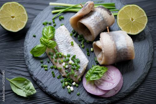 Fotografie, Obraz Close-up of a stone slate with herring fillet, studio shot