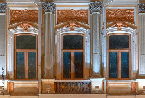 Three Windows In A Row And Balcony On Night Illuminated Three Windows In A Row And Balcony On Night Illuminated