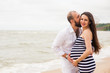 © freshstockplace - Beautiful young pregnant woman with man on the beach feel peace and tranquility