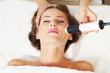 woman having facial peeling in beauty salon