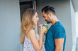 © jakubzak - Young couple are standing at the balcony and drinking a water.