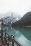 Fototapeta Sypialnia - Braies lake with wood building and mountains with trees