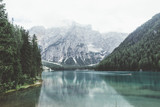 Fototapeta Sypialnia - Braies lake with green water and mountains with trees
