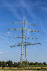 electric pylons transporting electricity through high tension ca