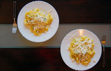 Ravioli filled with spinach and ricotta, Italian egg pasta, with fresh goat cheese on top