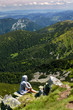© greenoline - Young woman sitting on mountain top. Jasna, Demianovska Dolina, Low Tatras, Slovakia.