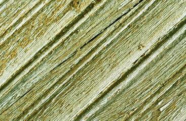 Weathered yellow painted wooden surface.