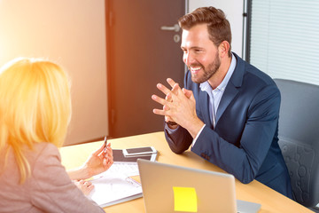 Young attractive employer doing a job interview to a woman