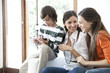 © PhotoAlto - Happy family using a digital tablet together at home