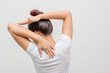 Back view portrait of a young woman stretching hands on  white background