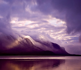 Wall Mural - Landscape. Mountains and lake in mist in morning with purple col