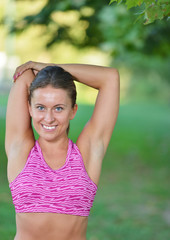 Wall Mural - Young girl stretching outdoors. Jogging - workout preparations.