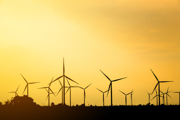 silhouette of wind turbine on sun set