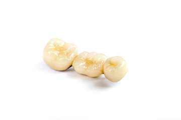 Wall Mural - Dental ceramic tooth crowns on white background. Isolated.