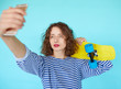 © kegfire - Hipster girl with skateboard making selfie