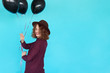 © kegfire - Young happy woman with black balloons having a birthday