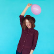 © kegfire - Trendy brunette girl wearing stylish hat, holding a pink balloon