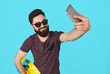 © kegfire - young handsome bearded hipster man makes selfie