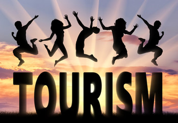 Wall Mural - Silhouette people jumping over the word tourism