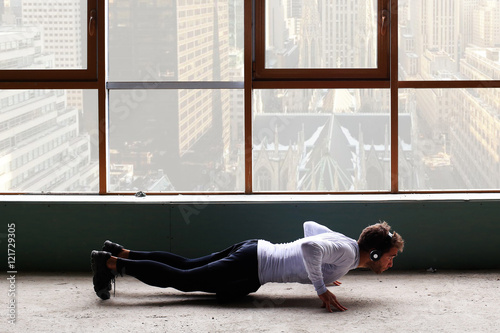 Poster Man with headphones training on the background of window