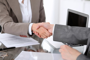 Wall Mural - Business handshake. Two women lawyers are shaking hands after meeting or  negotiation.