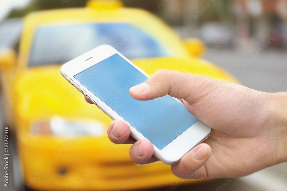 Male hand with cellphone calling taxi