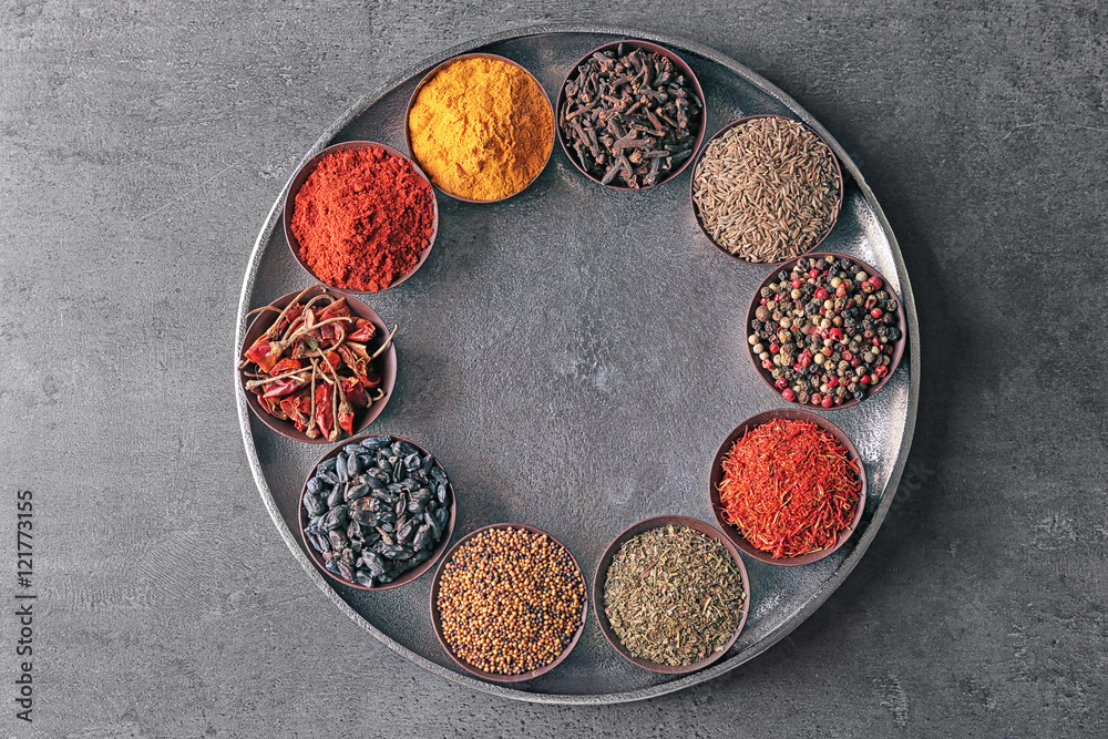 Different spices in bowls on plate