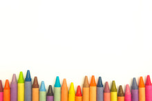 Colorful Crayons In An Irregular Row On White Background