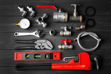 Poster - Plumber tools on a gray wooden background