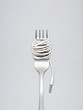 Food for new generation / A shining fork with noodle made of cable with music jack plug in metal background.