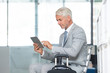 © Rido - Businessman using tablet at airport