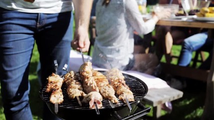 Wall Mural - man cooking meat on barbecue grill at summer party