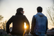 © theartofphoto - Two handsome casual trendy young men, 2 friends, in an urban park walking and chatting together