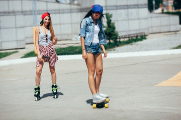 two young adult girls riding on the street