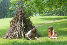 Kids Playing Next To Wooden Stick House Looking Like Indian Hut,