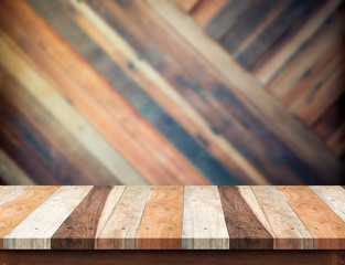 Poster - wooden table top at blurred diagonal wood plank wall,Template mo