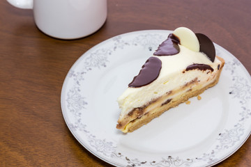 Milk chocolate pie on wooden table.