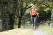© goodluz - Beautiful athletic woman running in forest