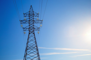 Wall Mural - Electricity pylon against blue sky