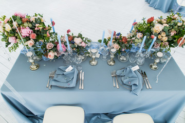 Wall Mural - A look from above on newlyweds dinner table covered with blue cl