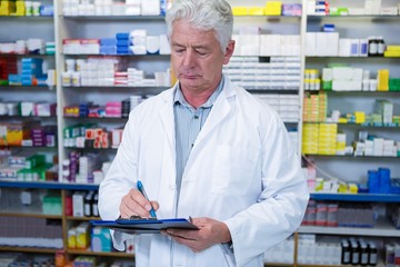 Wall Mural - Pharmacist writing on clipboard