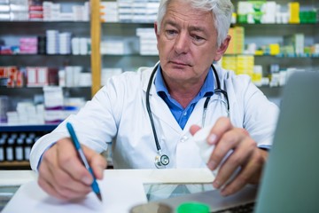 Wall Mural - Pharmacist writing prescriptions for medicines