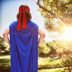 Poster - Composite image of boy in blue cape standing